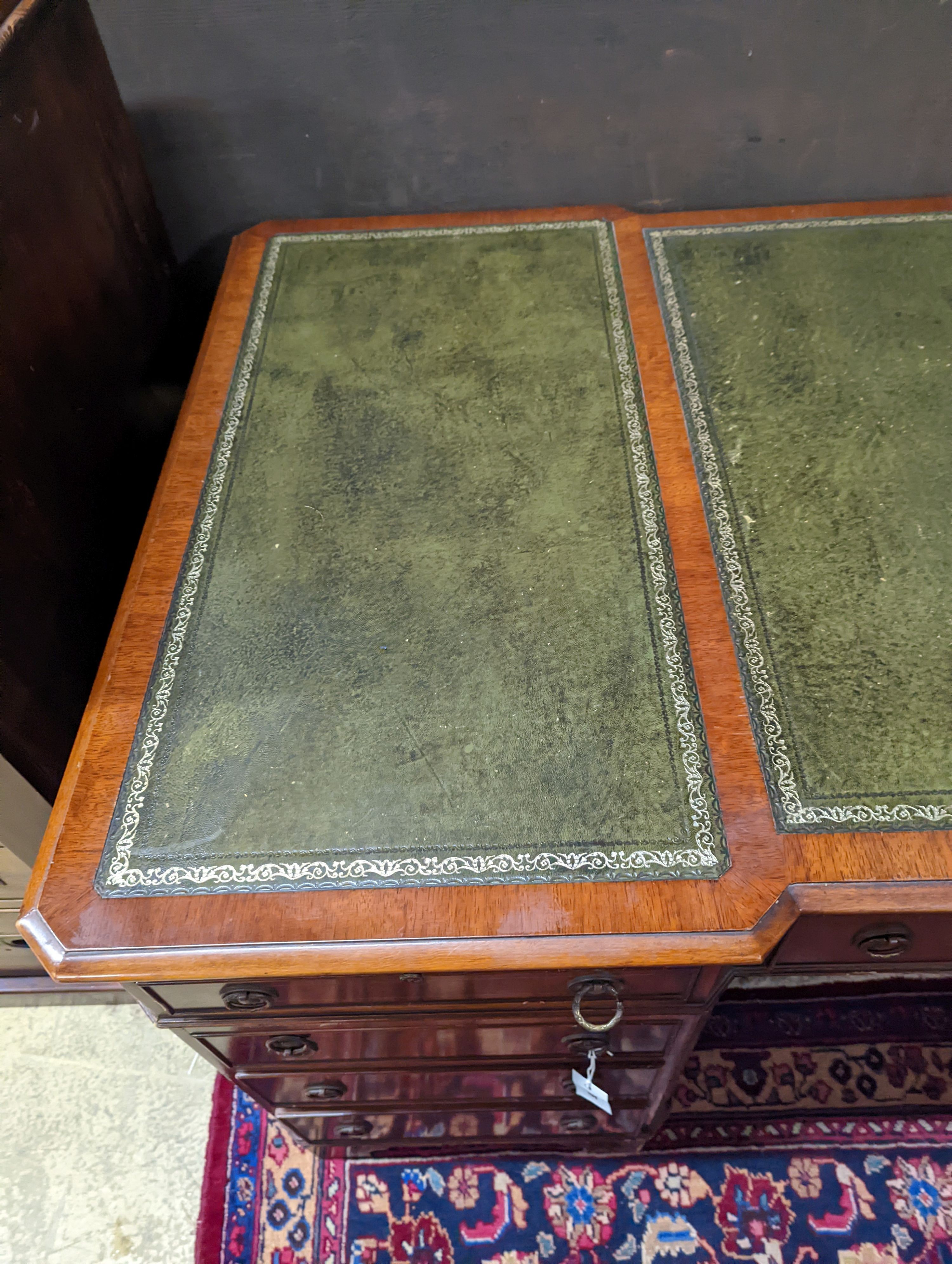 A reproduction George III style mahogany pedestal desk, length 150cm, depth 90cm, height 76cm